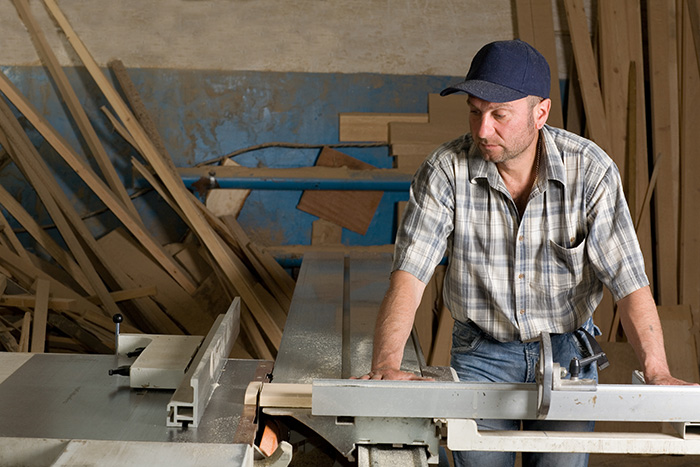 hearing aids in a noisy environment - Man Using Table Saw