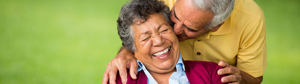 slow down hearing loss - man kissing his wife