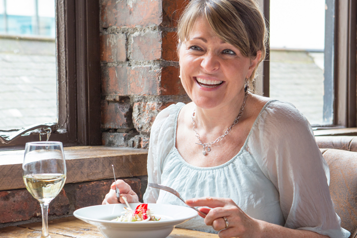 two hearing aids - woman eating at a restaurant