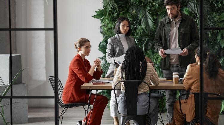 Press Release 2 - Group of diverse business professionals meeting in open room